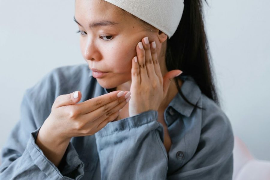 A woman massaging her face.