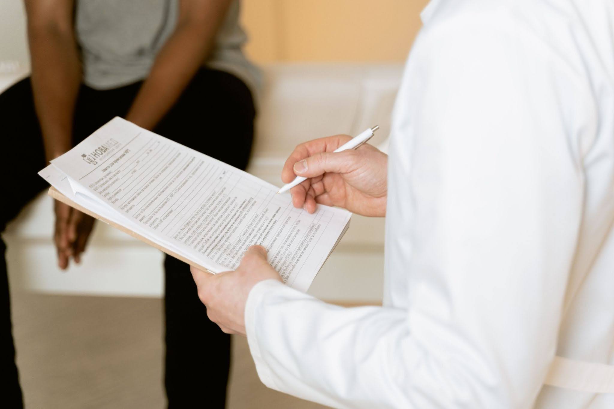 doctor going thru checklist with patient Doctor Going Thru Checklist With Patient