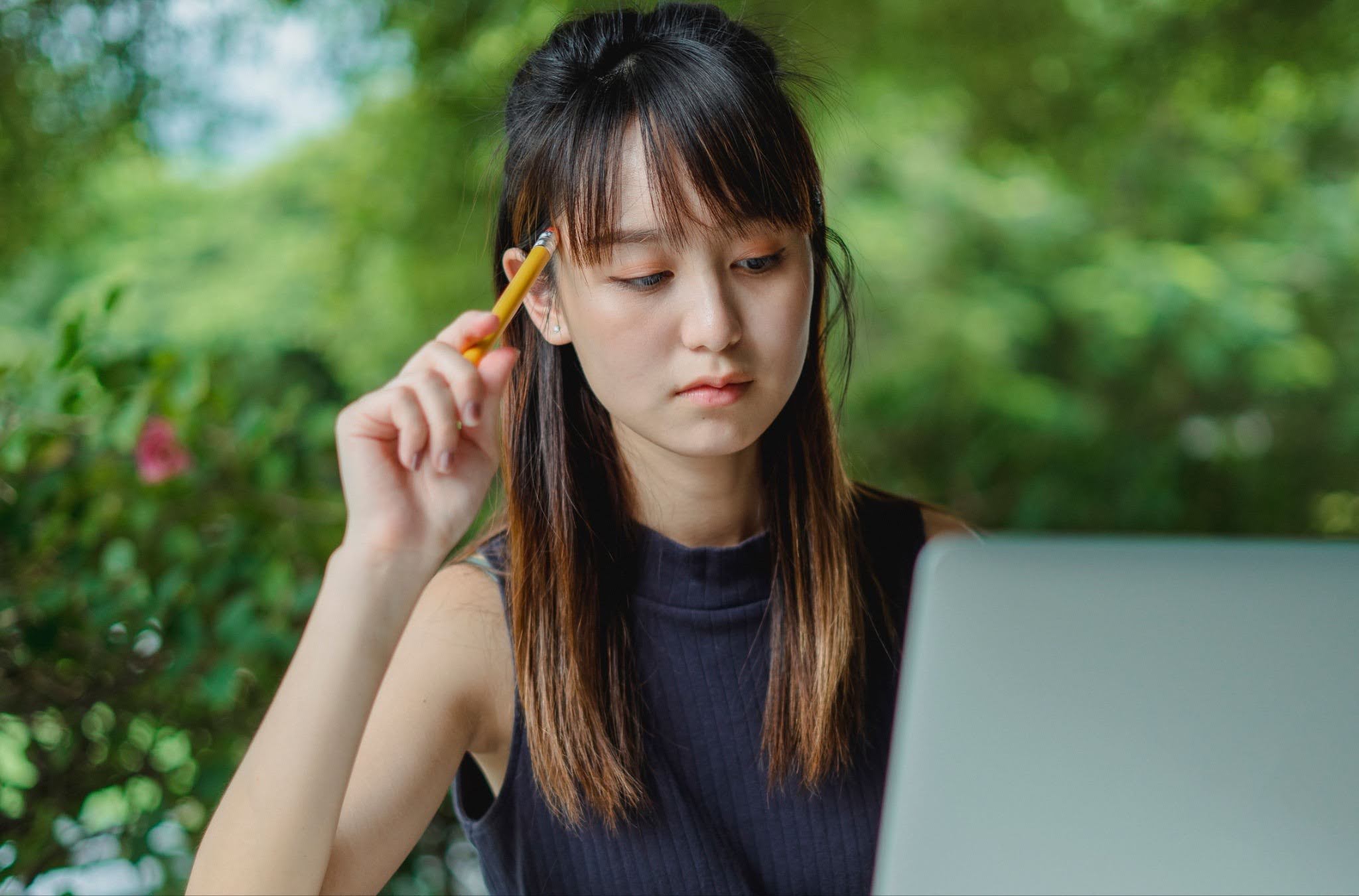 woman looking at her laptop and thinking Woman Looking At Her Laptop And Thinking